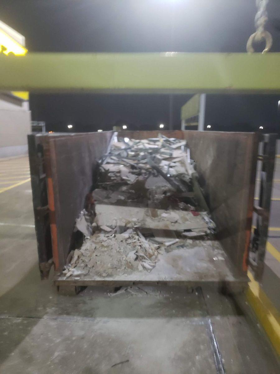 Roll-off bin of broken drywall from an interior tear-out