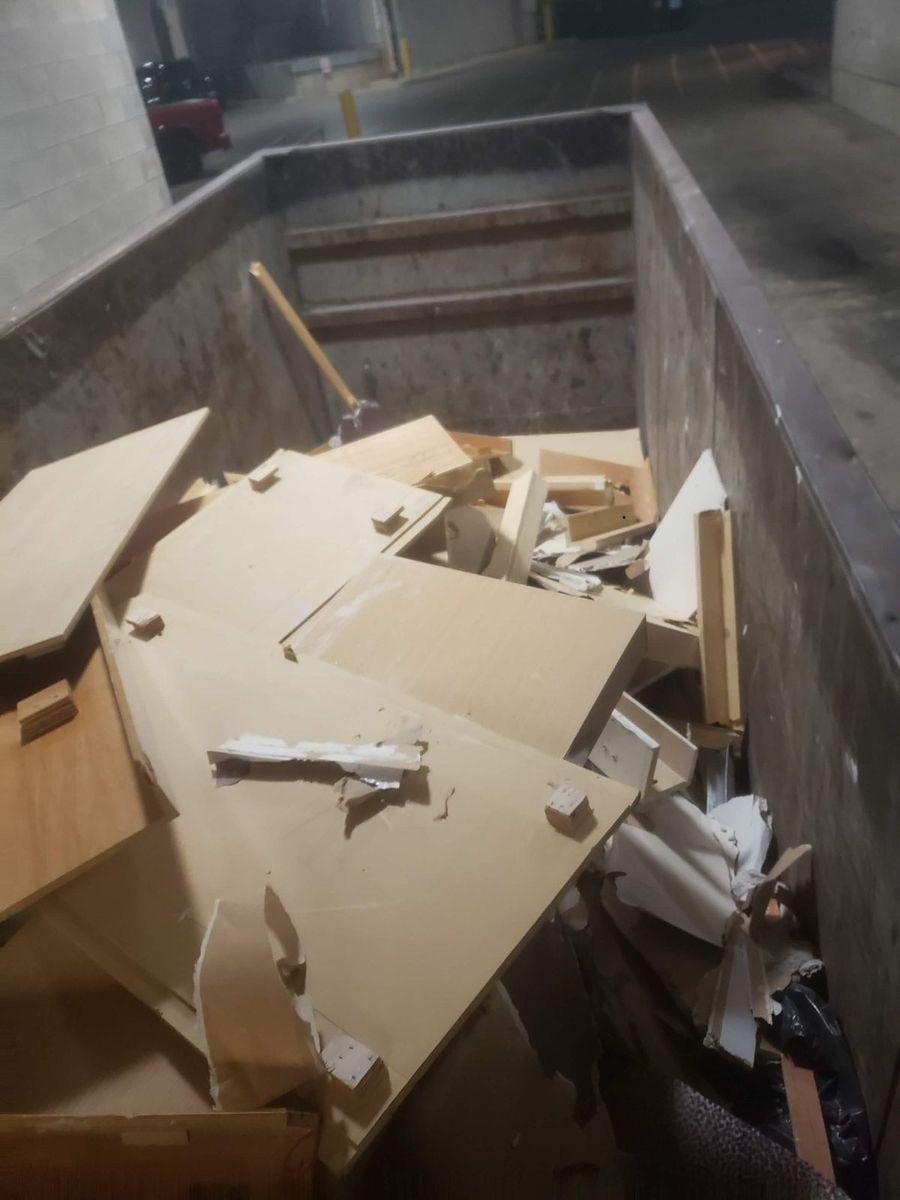 Bin of old cabinetry and particle board