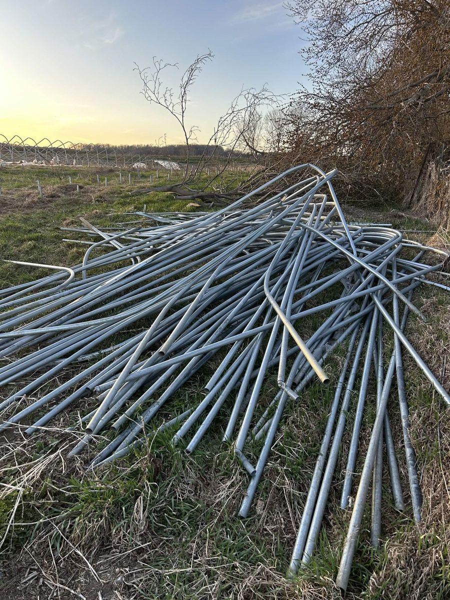 The dismantled metal frame stacked for hauling