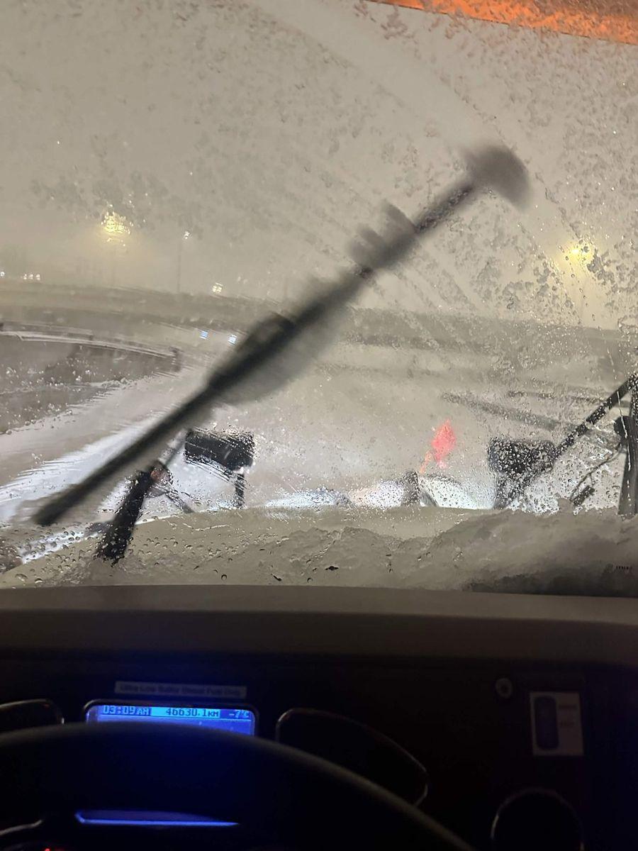 Plowing at night in heavy snow, seen from the cab