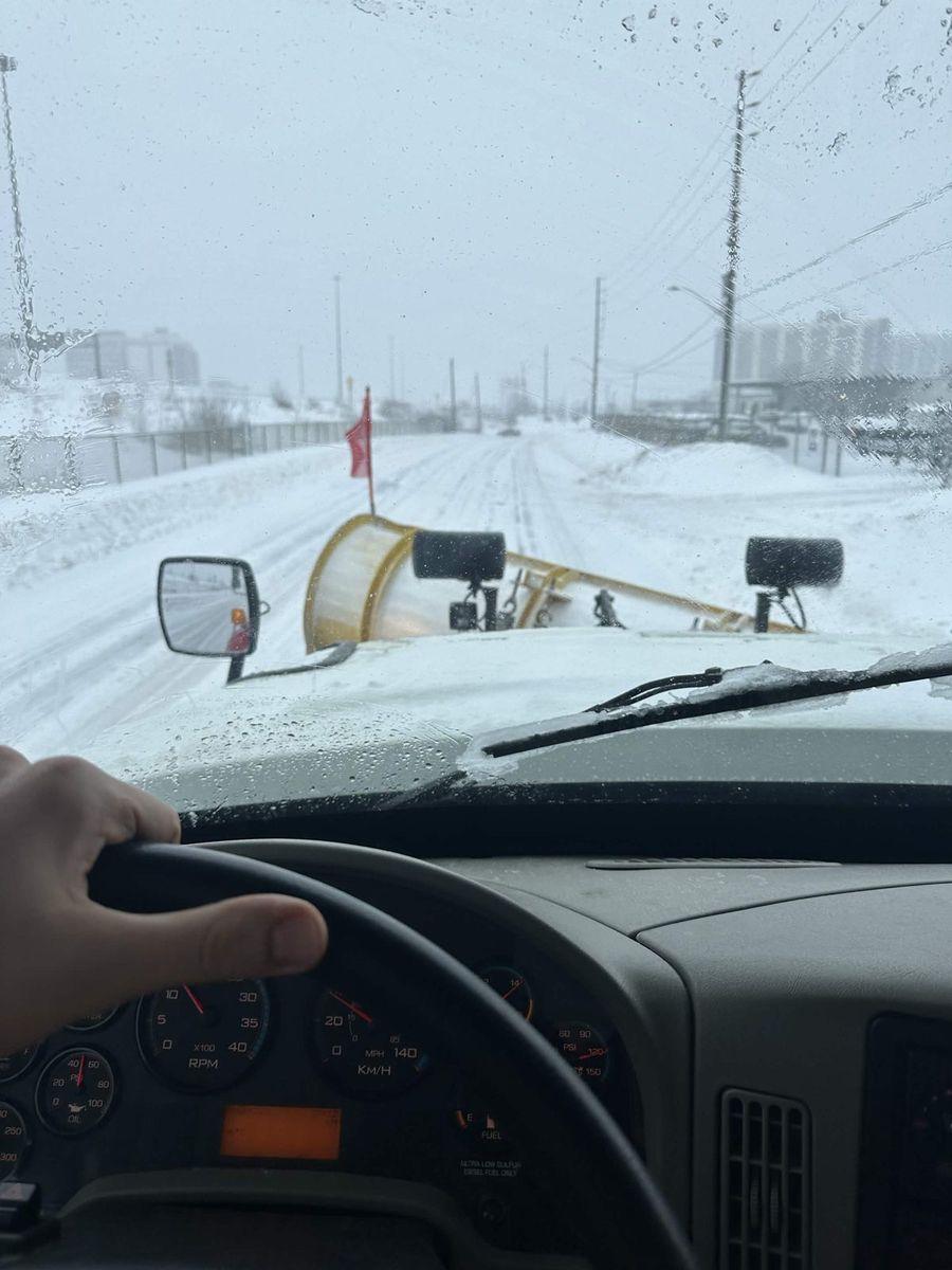 Clearing a snow-covered road in the morning